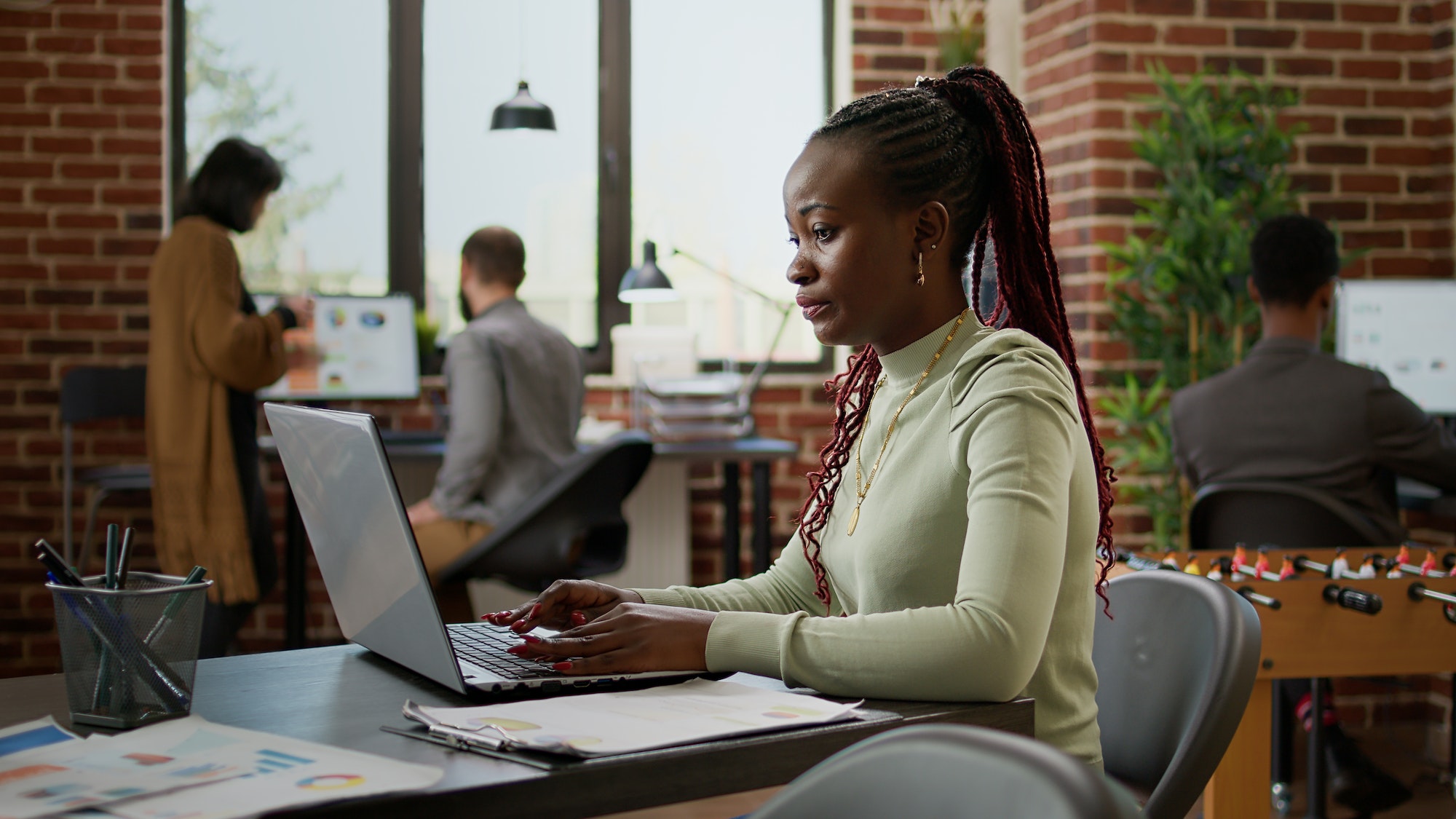 African american woman working on laptop in business office