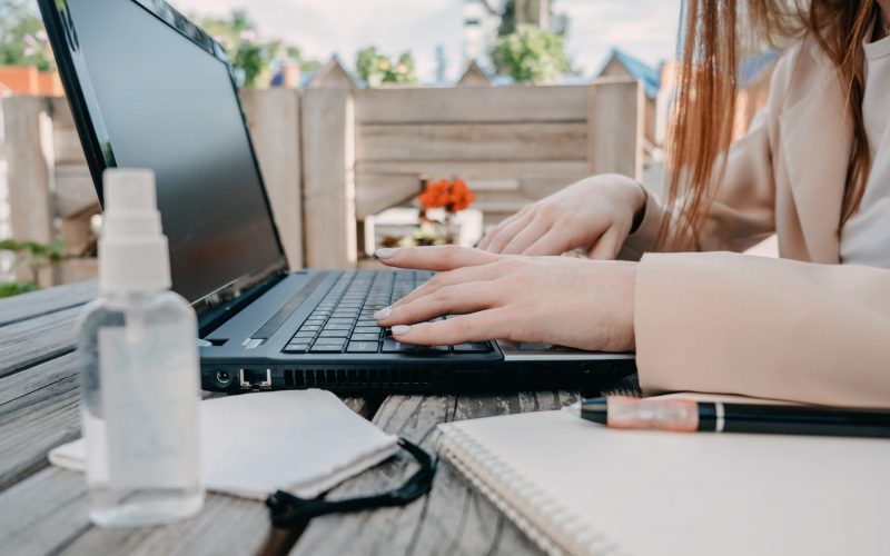 Data privacy, data wellbeing, management, personal information, digital identity, digital behavior, security issue, data hygiene, cybersecurity. Redhead woman entering data and starts work on laptop.